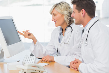 Doctors using computer at medical office