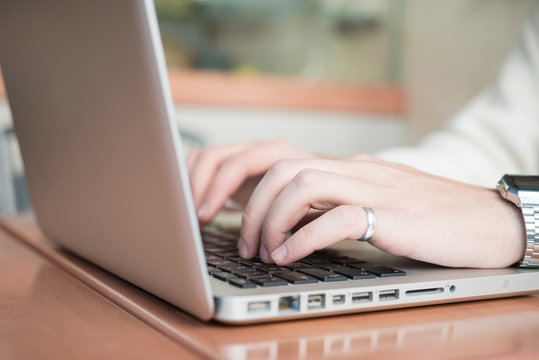 close up hands multitasking man using tablet, laptop and cellhpo