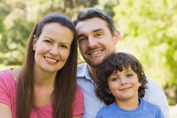 Close-up of a smiling couple with son in park