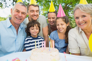 Family with cake outdoors