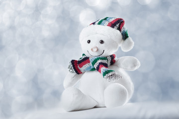 happy snowman with lights in the background