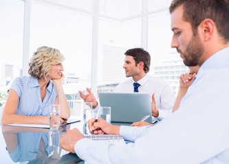Executives sitting around conference table