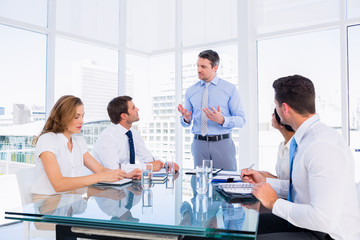 Executives sitting around conference table