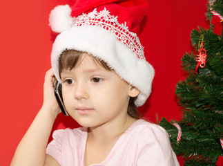 girl in Santa hat upset telephone conversation