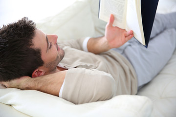 Man in sofa reading book