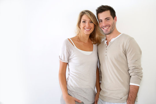 Cheerful couple standing on white background