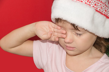 girl in Santa hat upset and crying