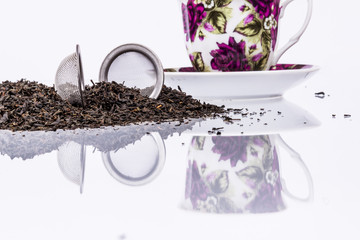 Cup and black tea on white background.