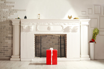 Red gift box on the background of home interior