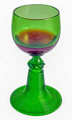 old green glass with wine on a white background