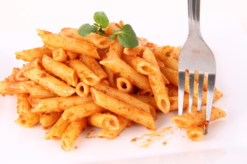 Pesto rosso being decorated with cress being eaten with a fork