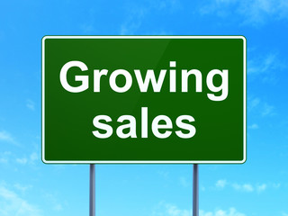 Finance concept: Growing Sales on road sign background