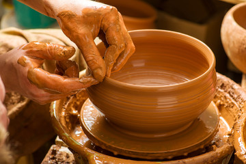 hands of a potter, creating an earthen jar