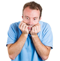 Naklejka premium Stressed young man biting his fingernails, looking anxious