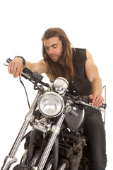 Obraz na płótnie Canvas man leather vest motorcycle look down