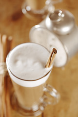 coffee latte with cinnamon sticks, focus on stiks end, , shallow