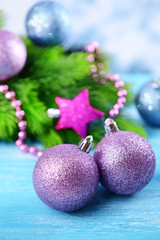 Christmas balls on fir tree, on color background