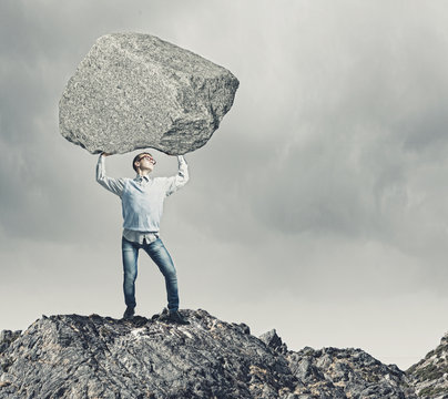 Guy Lifting Stone