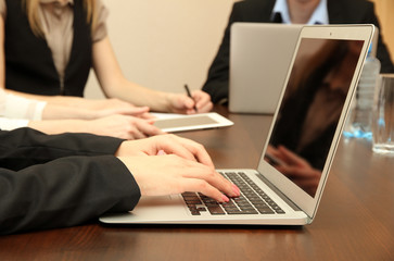 Female hands with digital tablet on office background.