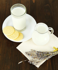 Milk and cookies on a wooden background