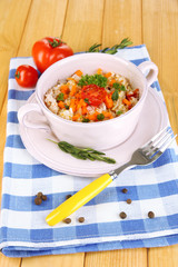 Delicious rice with vegetables and herbs in pot