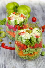 Tasty salad with fresh vegetables on wooden table