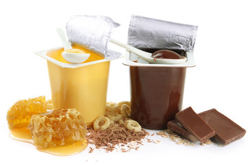 Tasty desserts in open plastic cups and honey combs, isolated