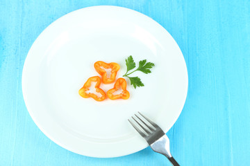 Small portion of food on big plate on wooden table close-up