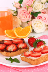 Delicious toast with strawberry on plate close-up