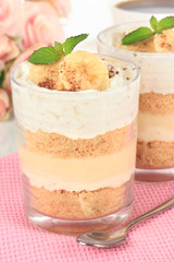Delicious dessert with banana and caramel on table close-up