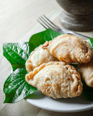 Snack of curry puffs on dish