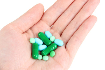 Pills in hand isolated on white