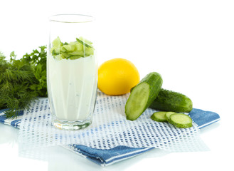Cucumber yogurt in glass, on color napkin, isolated on white