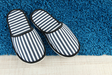 Striped slippers on floor background