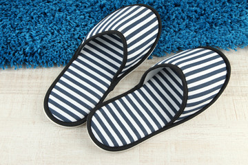 Striped slippers on floor background