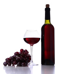 Wineglass with red wine, grape and bottle isolated on white