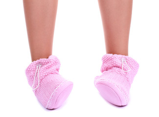 Female legs in home winter shoes, isolated on white