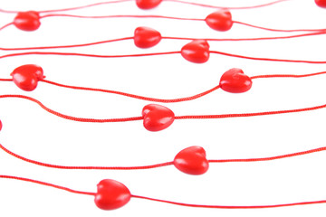 Heart-shaped beads on string isolated on white