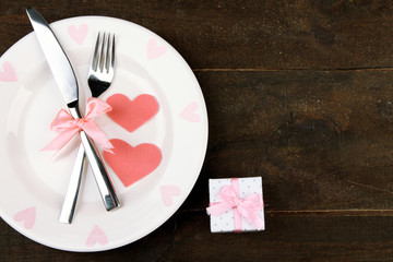 Romantic holiday table setting, on wooden background