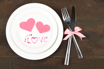 Romantic holiday table setting, on wooden background