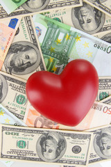 Fototapeta na wymiar Love and money concept. Heart on European and American money