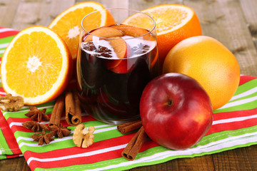 Fragrant mulled wine in glass on napkin close-up