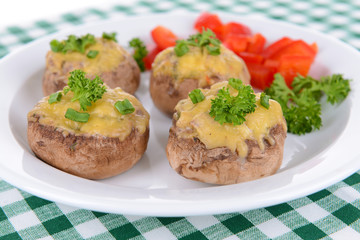 Stuffed mushrooms on plate on table close-up