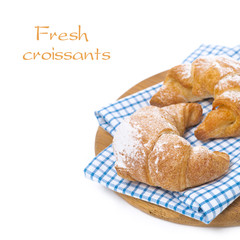 fresh croissants on a wooden board, isolated