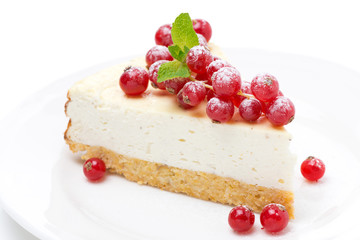 vanilla cheesecake with red currants on a plate