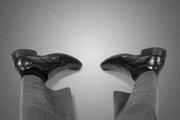 Fatigue and workaholism concept.Feet of the lying businessman.