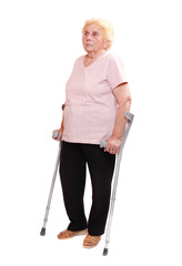 Happy elderly woman with her crutches.