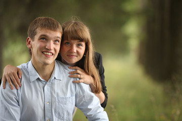 Fototapeta premium embracing and kissing young guy and girl on nature
