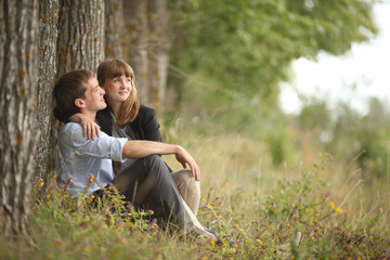 Fototapeta premium embracing and kissing young guy and girl on nature