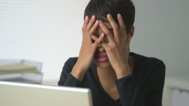 Black business woman expressing frustration at work